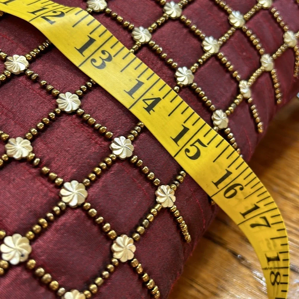 Pier 1 wine accent pillow with beaded details in gold.  Some beads missing. 16”.